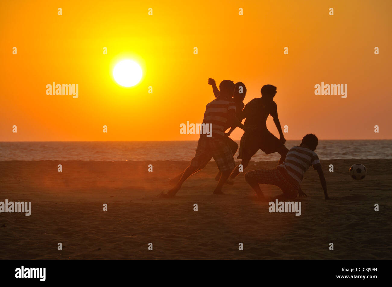 Evening, dusk, evening light, evening sun, evening mood, Asia, Ceylon, leisure, activity, football, soccer, player, footballer, Stock Photo