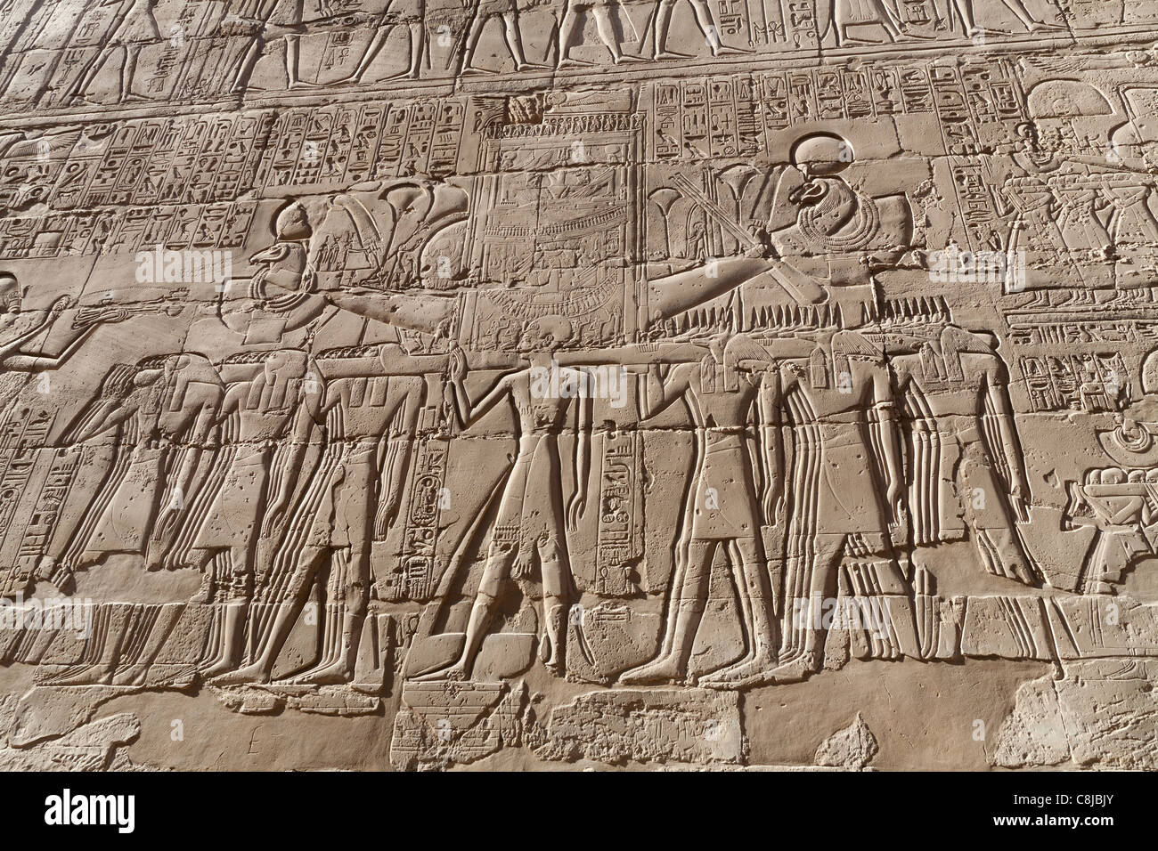 Relief work showing Barque of Amun carried by the spirits of  Pe and Nekhen at Karnak Temple, Luxor Egypt Stock Photo