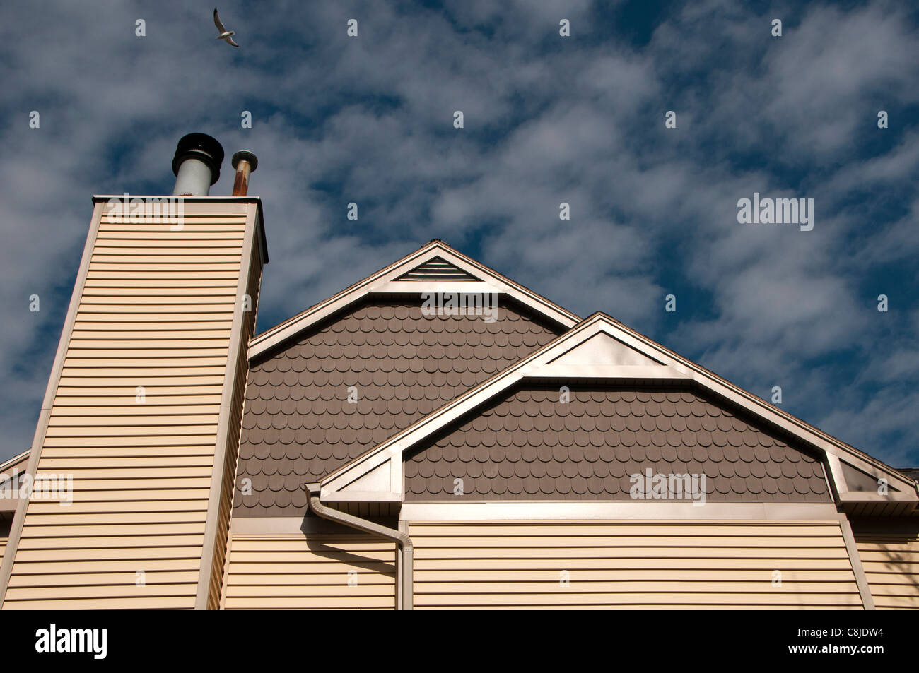 Detail of home with cirrocumulus clouds. Stock Photo
