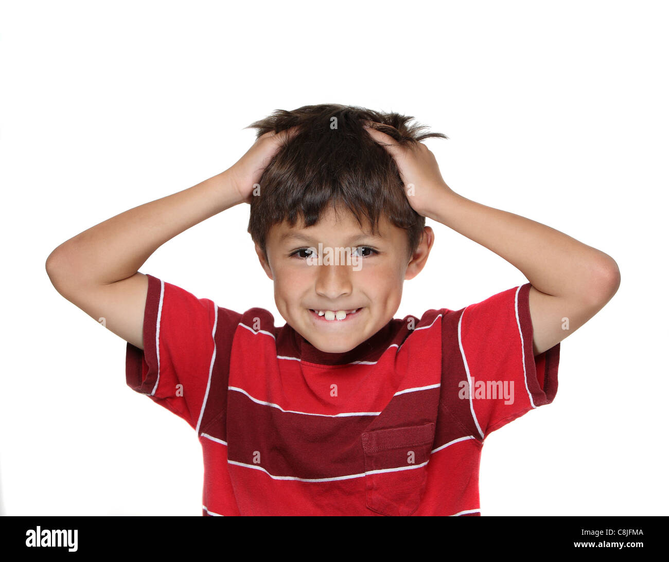 Exasperated or frustrated young boy with hands grabbing his hair