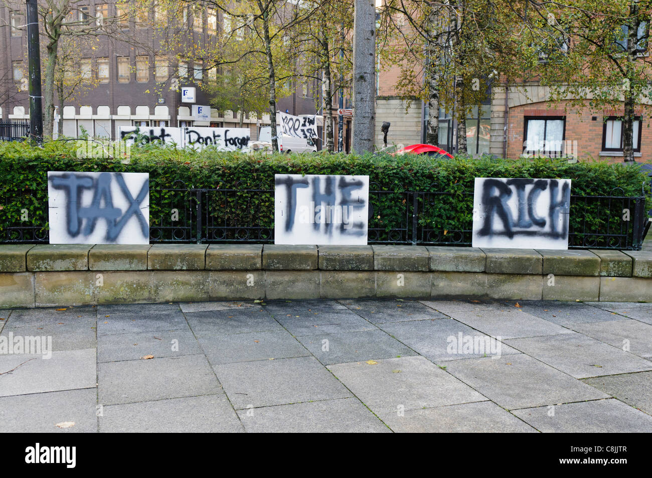 Belfast, UK, 26/10/2011. Sign calling for governments to tax the rich at Occupy Belfast protest. Stock Photo