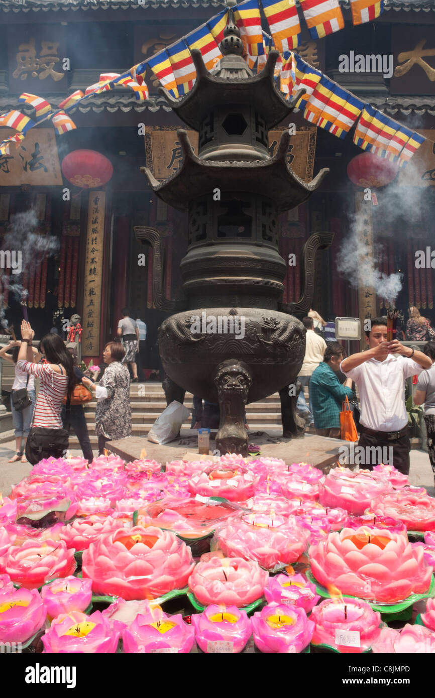 Pink Lotus Candles and worshipers; Jade Buddha Temple; Shanghai Stock Photo
