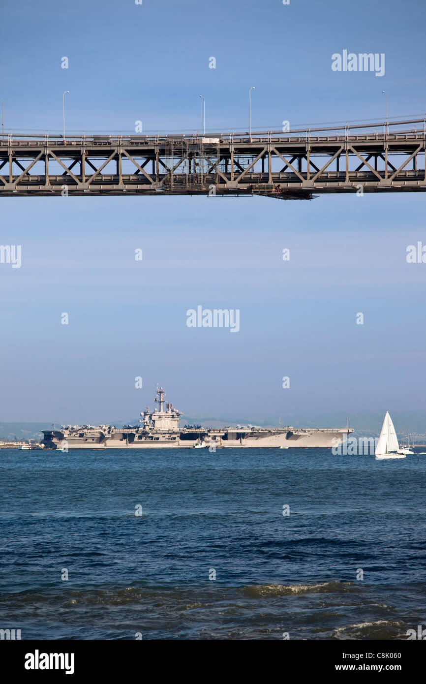 US Navy Aircraft Carrier CVN-70 Carl Vinson moored beyond the Bay Bridge during Fleet Week in San Francisco California, USA Stock Photo
