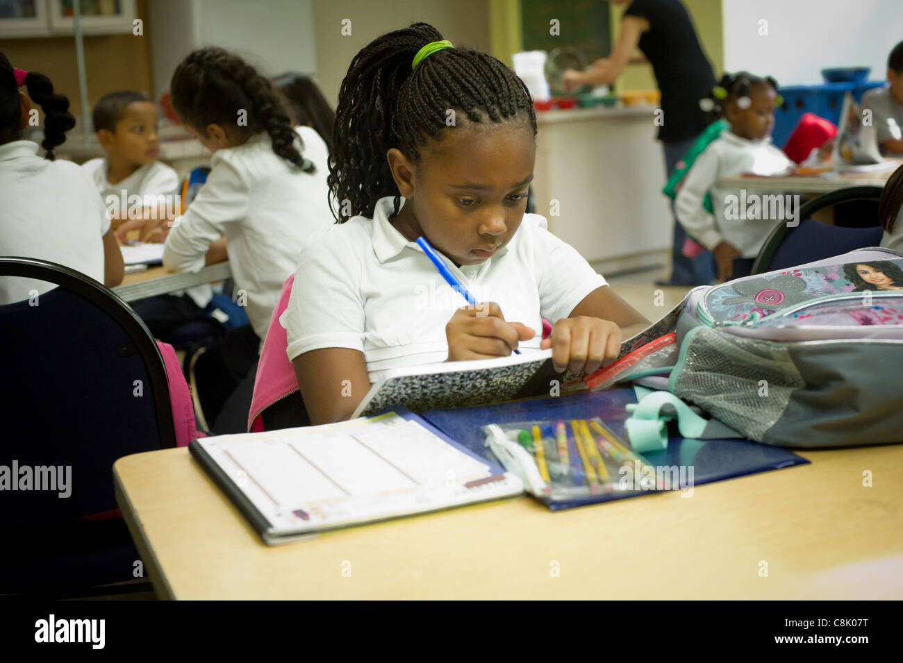 Second and third graders do homework during an after school program in