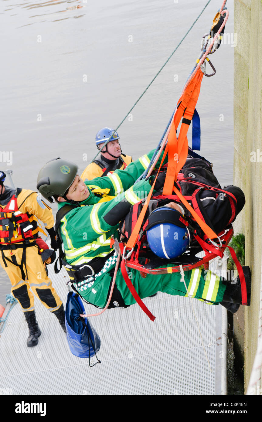 Paramedic is winched up on a rope with a patient during the launch of