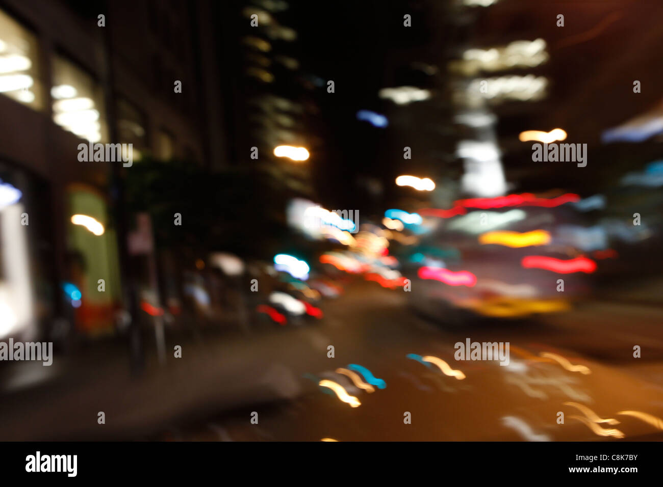 Blurry night city lights from a car while driving. Stock Photo