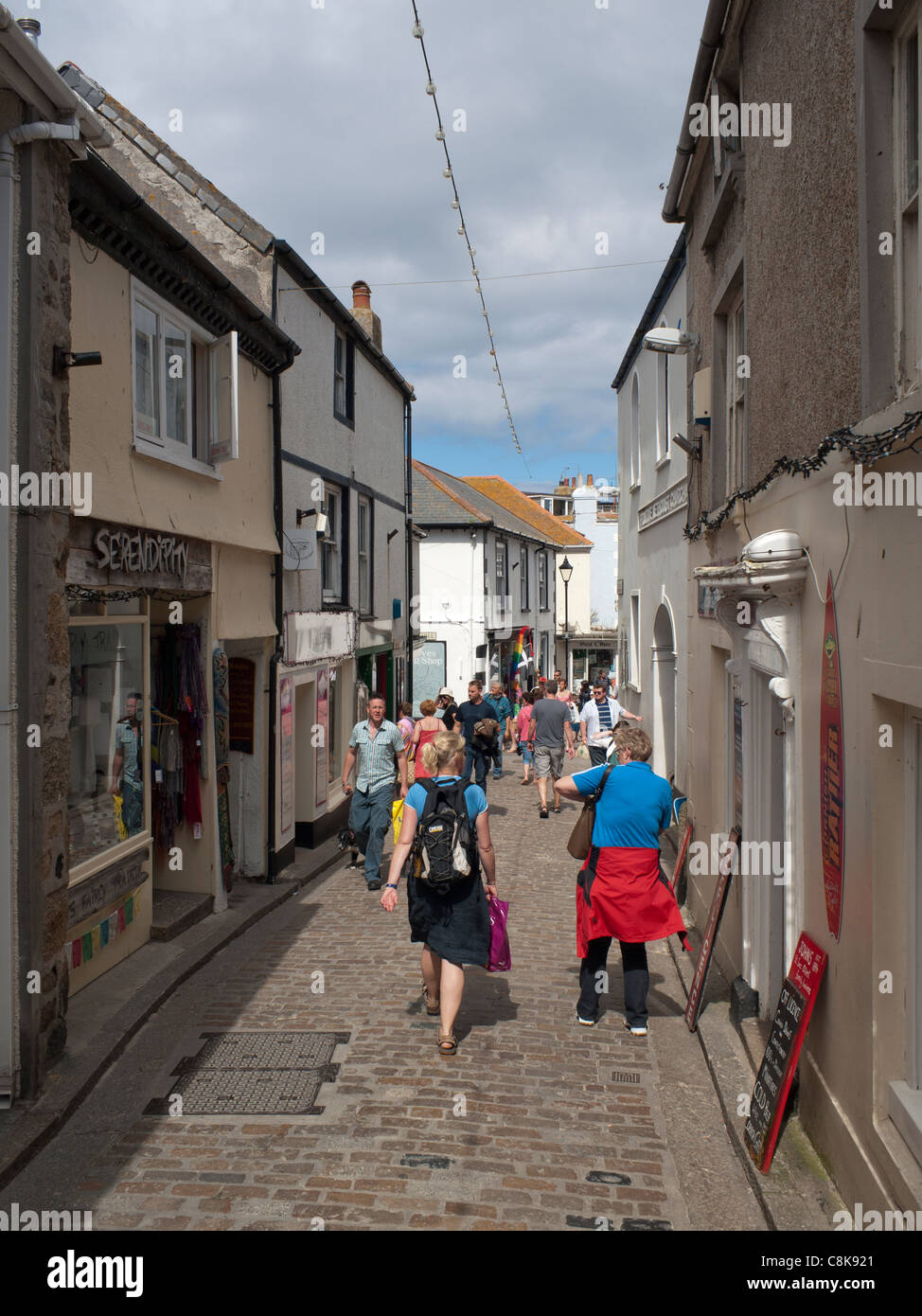Fore Street in St. Ives, a narrow cobblestone street with shops on both sides. Stock Photo