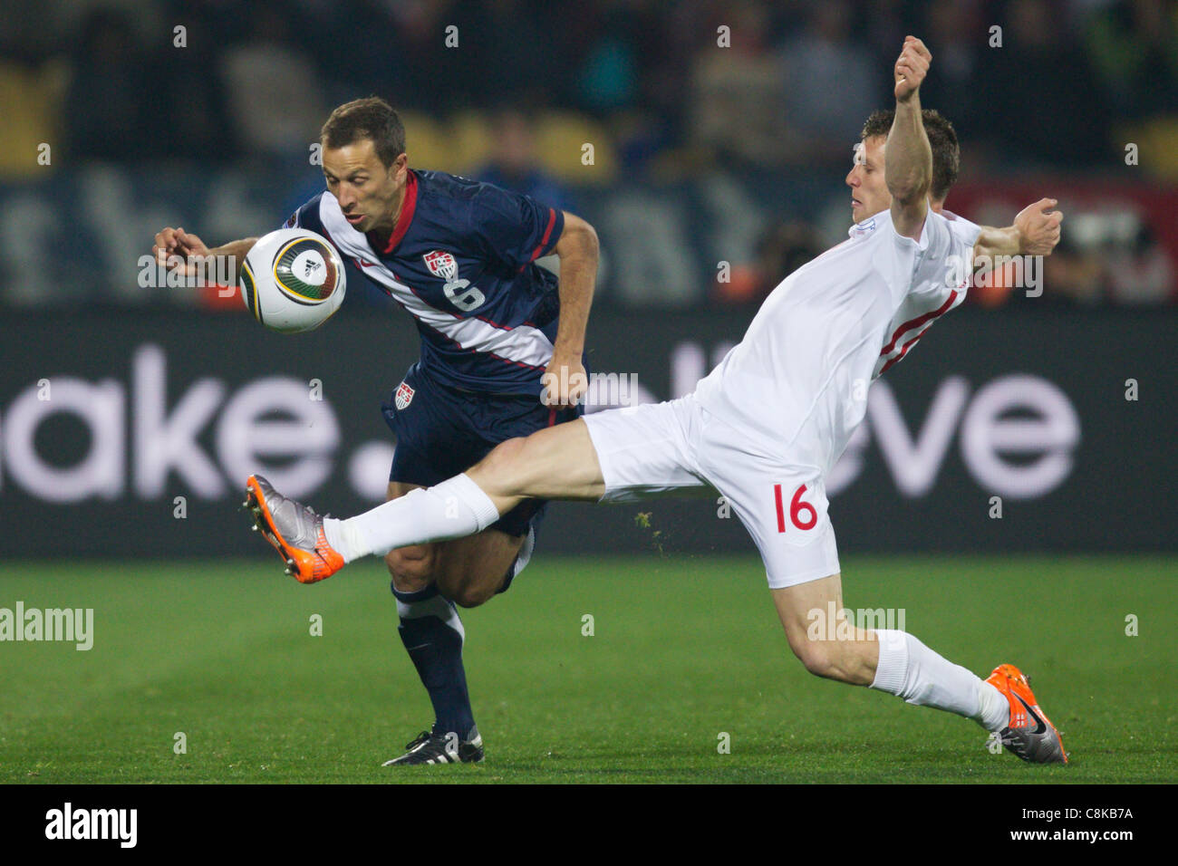 James Milner of England (R) stretches for the ball against Steve Cherundolo of the USA (L) during a 2010 FIFA World Cup match. Stock Photo