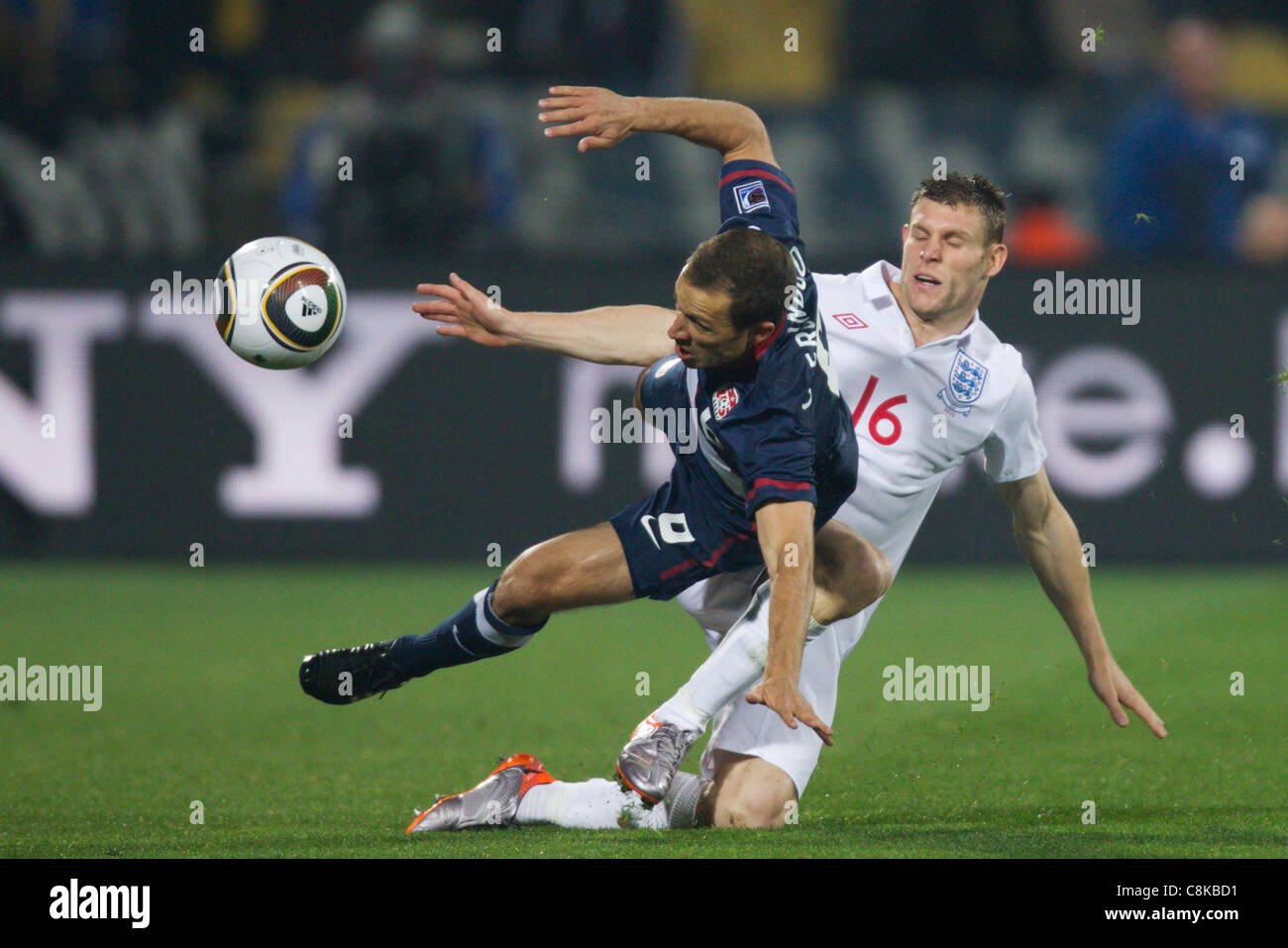James Milner of England (R) tackles Steve Cherundolo of the United States (L) during a 2010 FIFA World Cup Group C match. Stock Photo