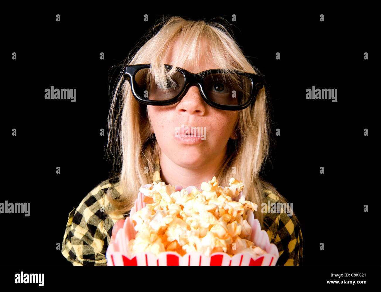 An Adorable Child Engrossed by a 3-D Movie Stock Photo