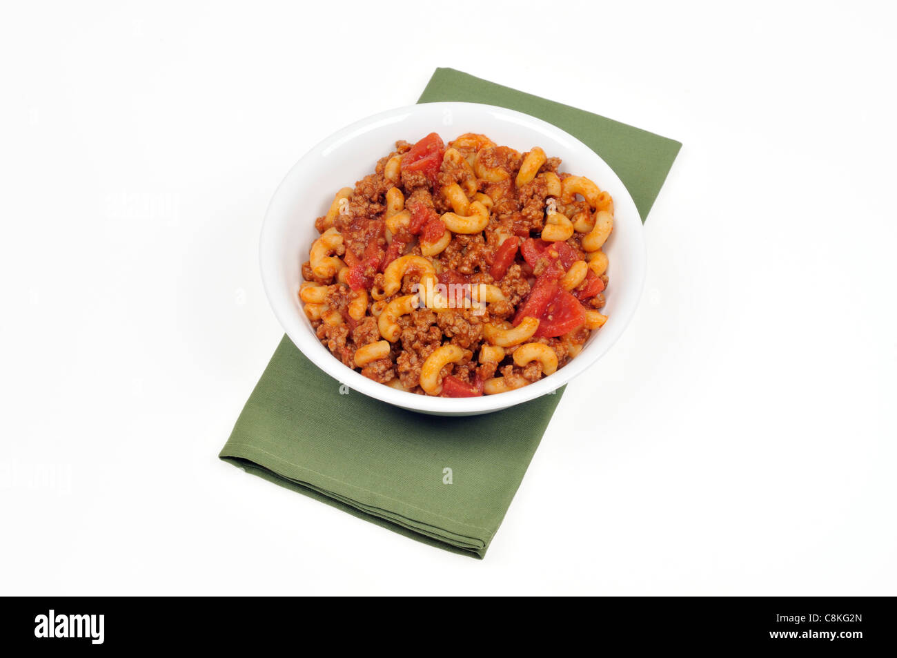 Bowl of macaroni and beef with tomato sauce on white background cutout. Stock Photo