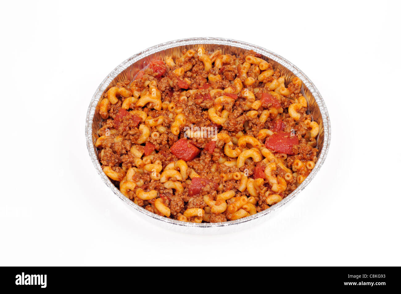 Takeaway tin of cooked macaroni and beef with tomatoes on white background, cutout. Stock Photo