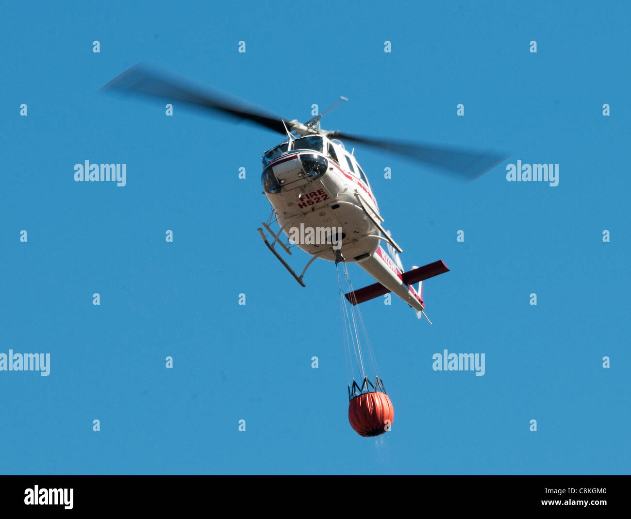 Firefighting helicopter carrying water to Extinguish Wildfire in