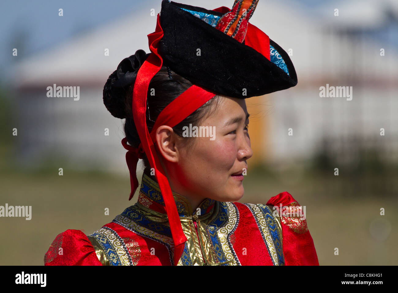 Mongolian woman in traditional dress at a tourist ger camp in Mongolia ...