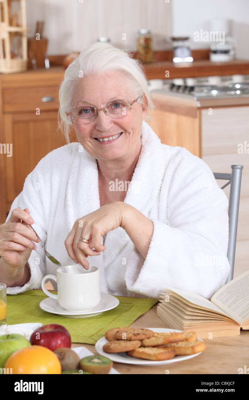 granny in the kitchen having breakfast Stock Photo Alamy