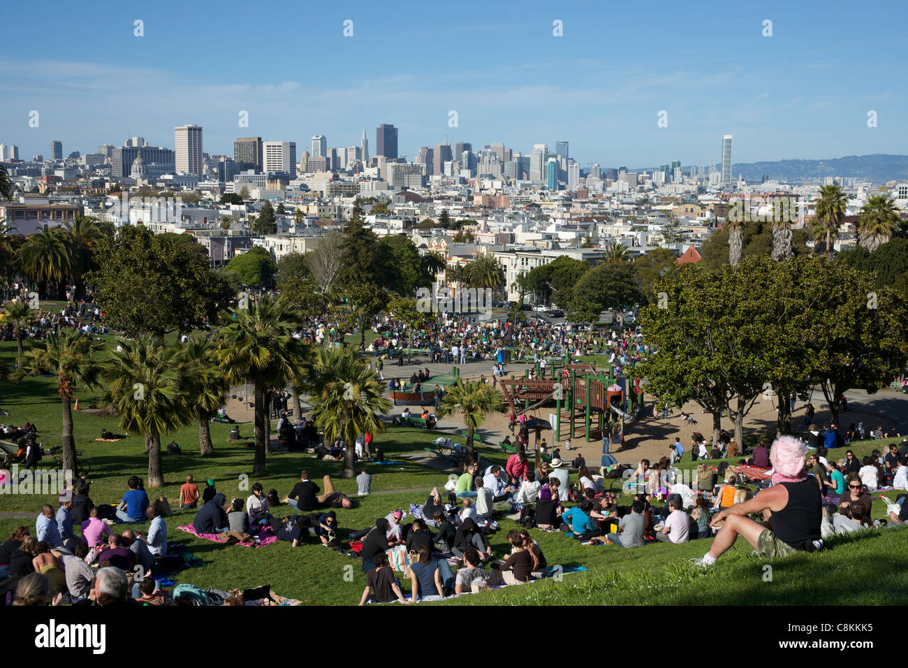 People in the Dolores park with San Francisco view on the background