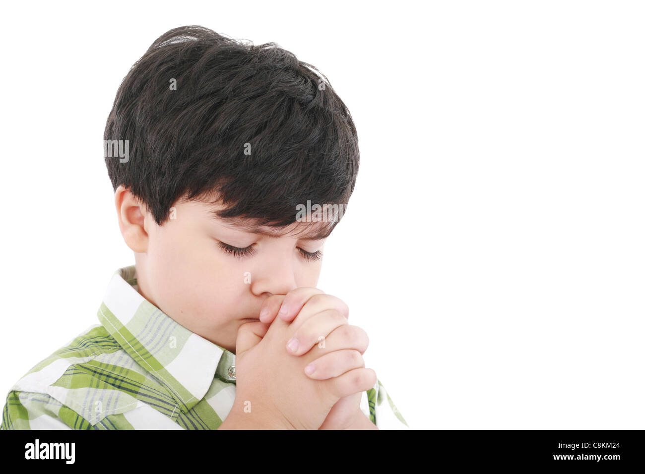 A boys prays earnestly to his creator in heaven Stock Photo