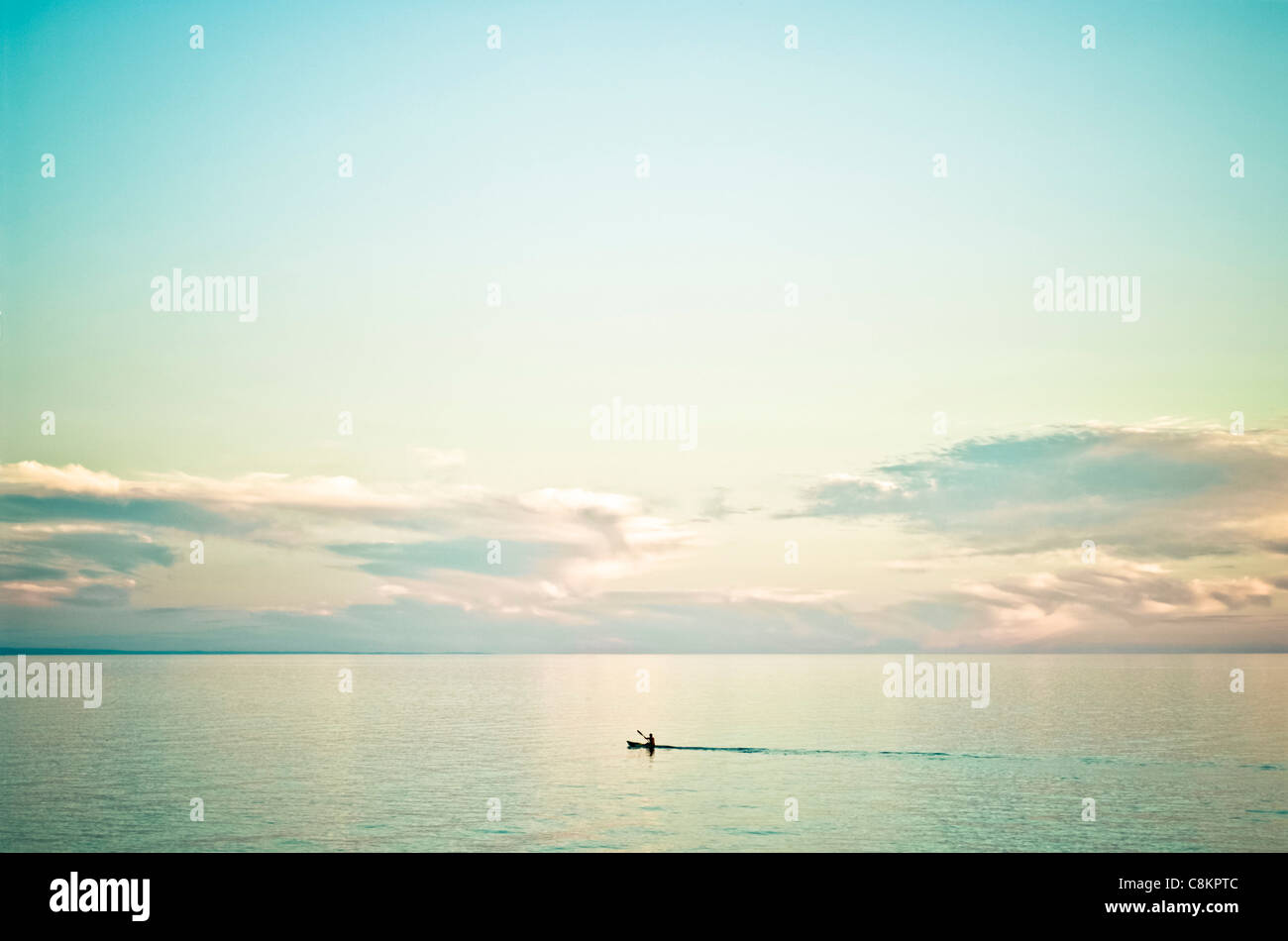 One surfski paddler on tranquil sea Stock Photo