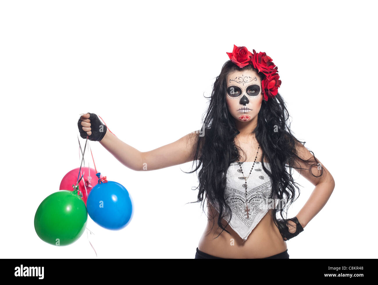 disappointed woman in day of the dead mask with ballons dressed up for All Souls Day Stock Photo