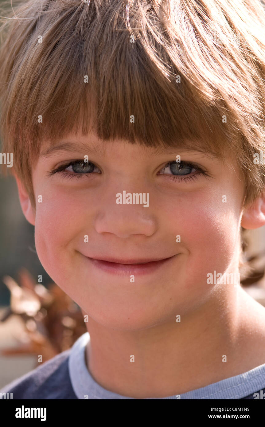 Head and shoulders portrait of a little boy with brown hair Stock Photo