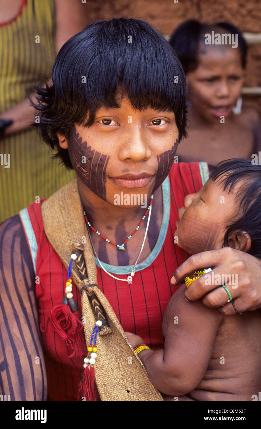 A - Ukre village, Xingu, Brazil. Young Kayapo Indian woman with her child; black face paint. Stock Photo