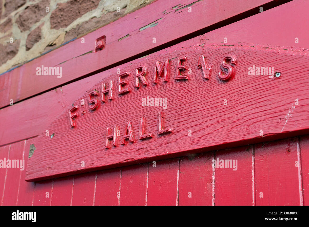The large, red, wooden sliding door of the Fishermen's Hall in North Berwick, East Lothian, Scotland. Stock Photo
