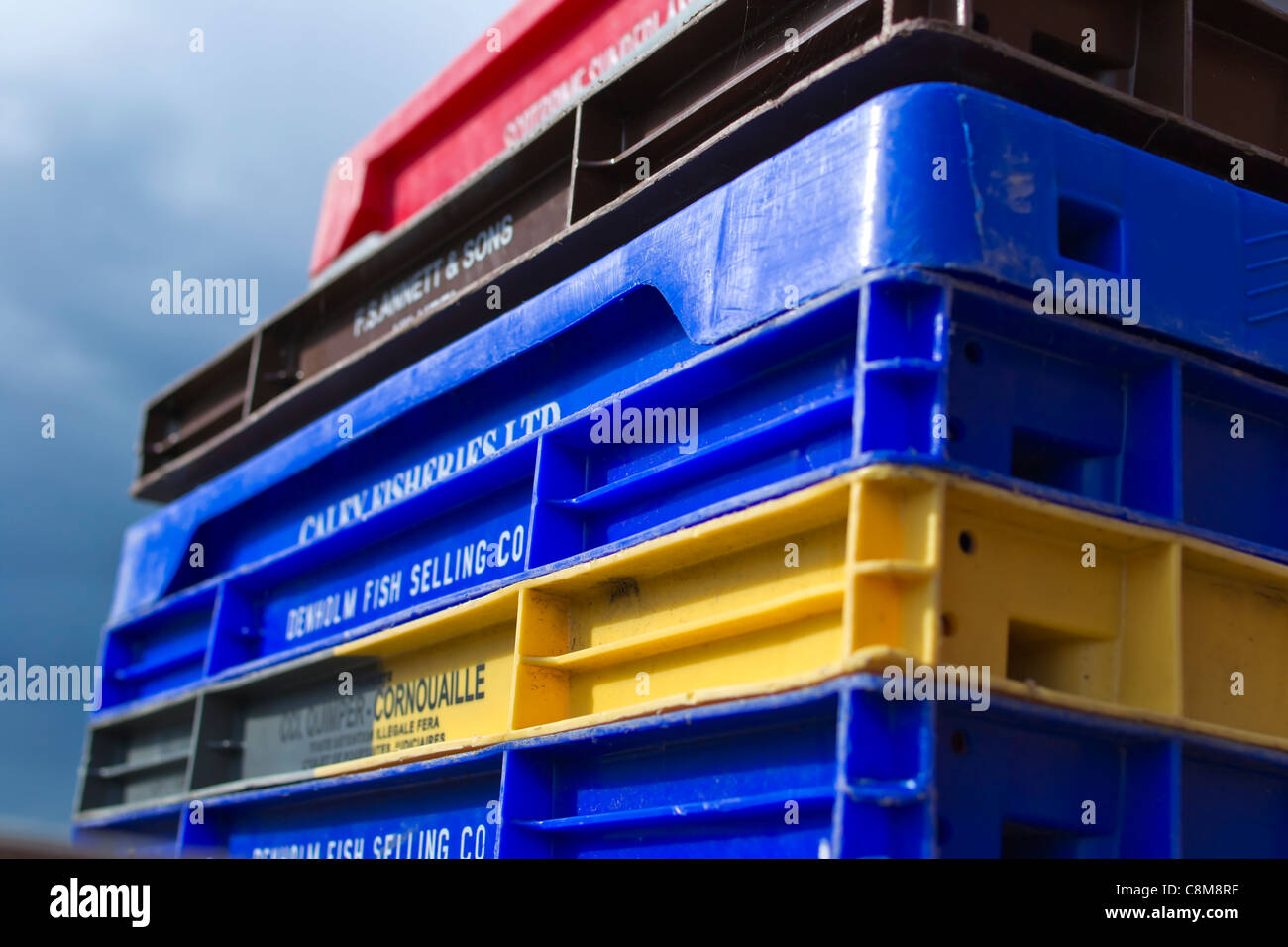 A stack of colourful plastic boxes used to land fish from fishing boats