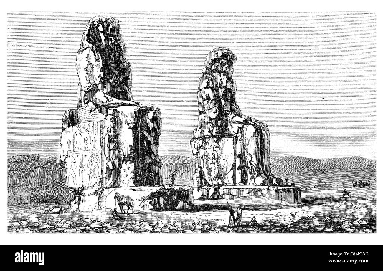 Colossi Memnon two massive stone statues Pharaoh Amenhotep III Theban necropolis River Nile Luxor statue craft sculpture Stock Photo