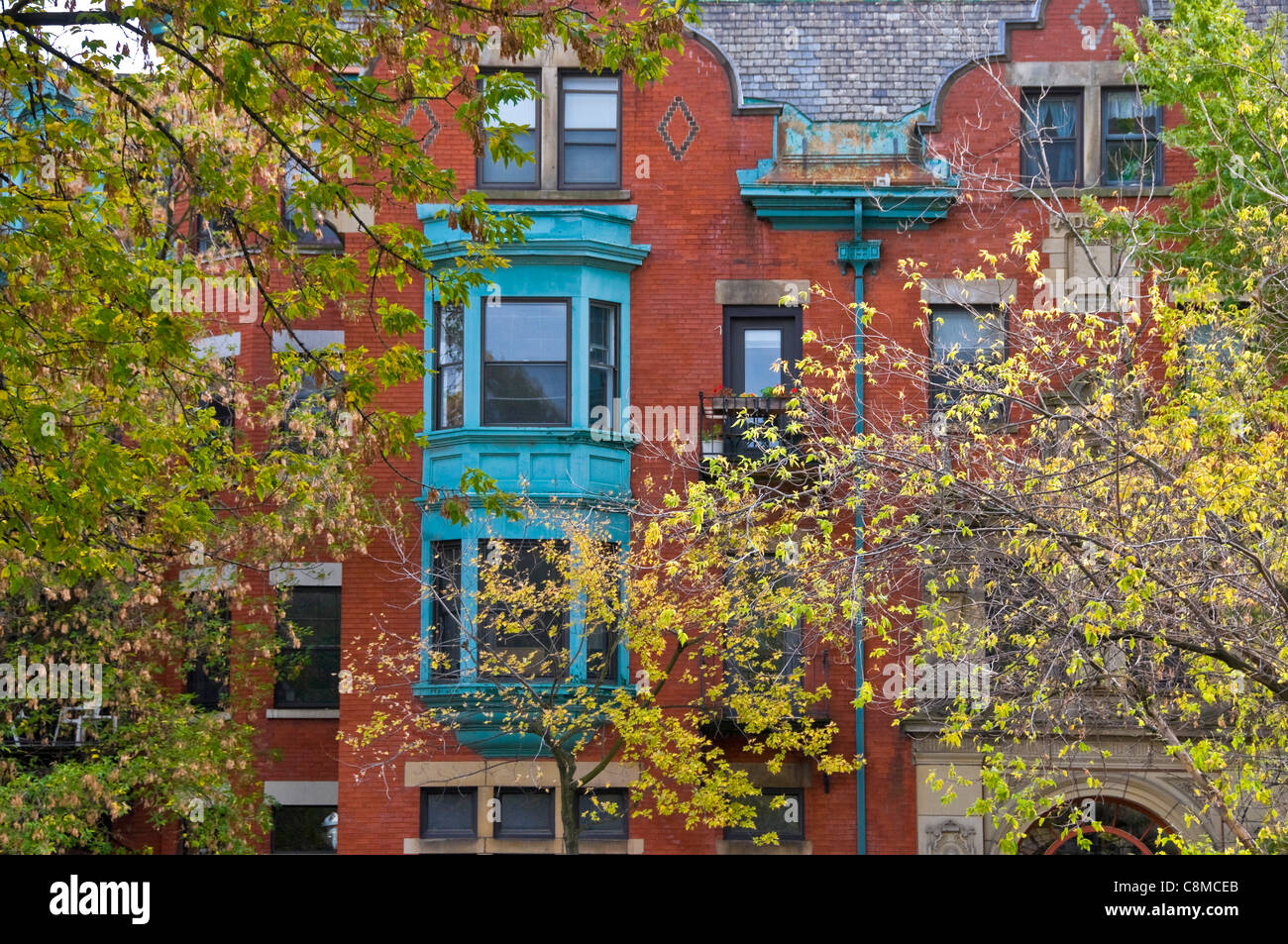 Victorian buildings and foliage on Milton street downtown Montreal Canada Stock Photo