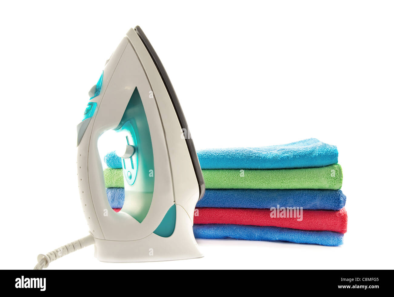 stack of colorful towels and electric iron is isolated on white Stock Photo