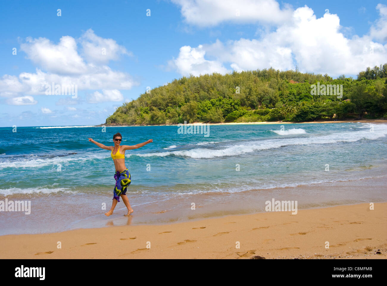 Young woman, age 21, walking and playing on Molowaa beach, north shore on the island of Kauai Stock Photo