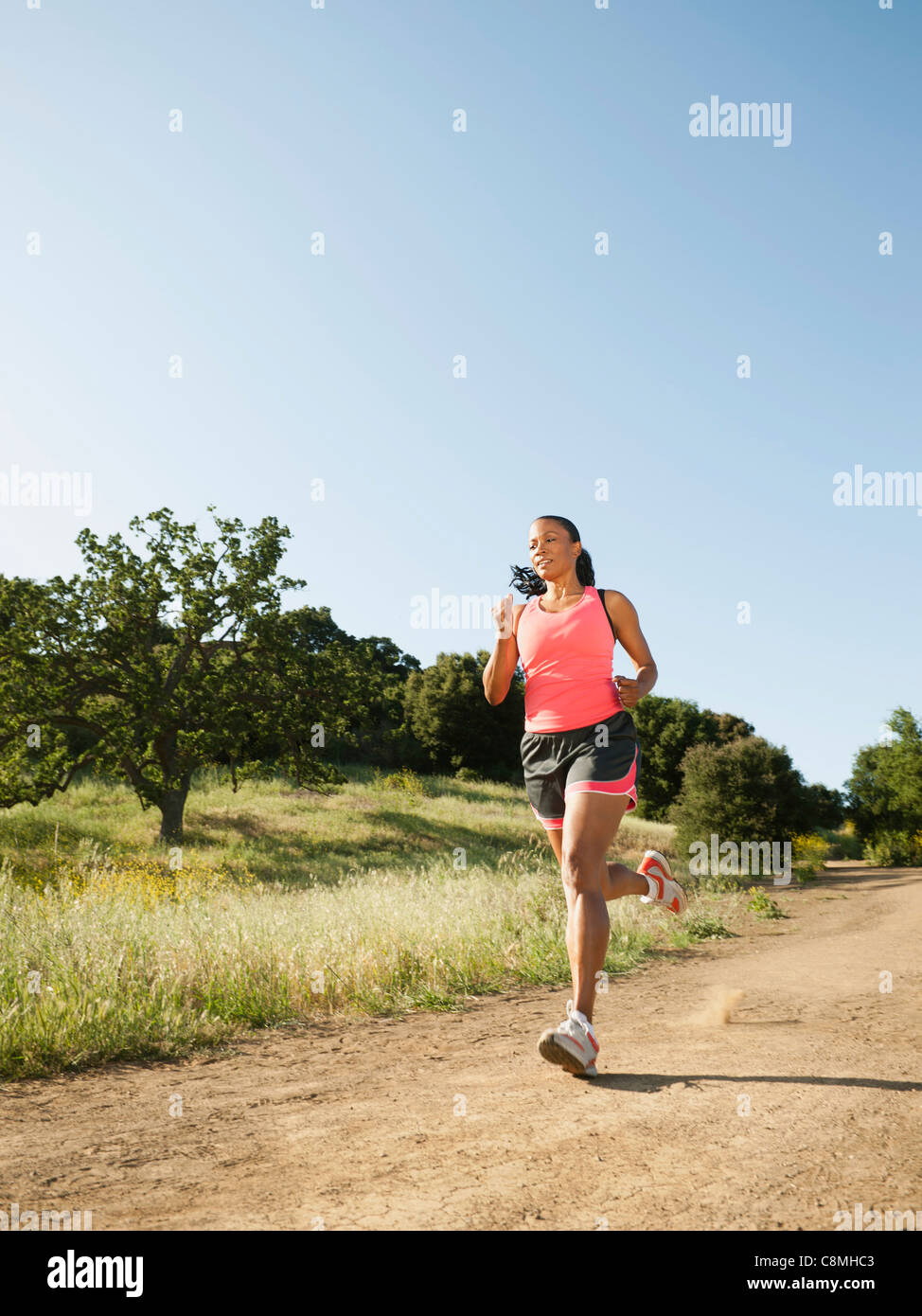 Black woman running on remote trail Stock Photo - Alamy