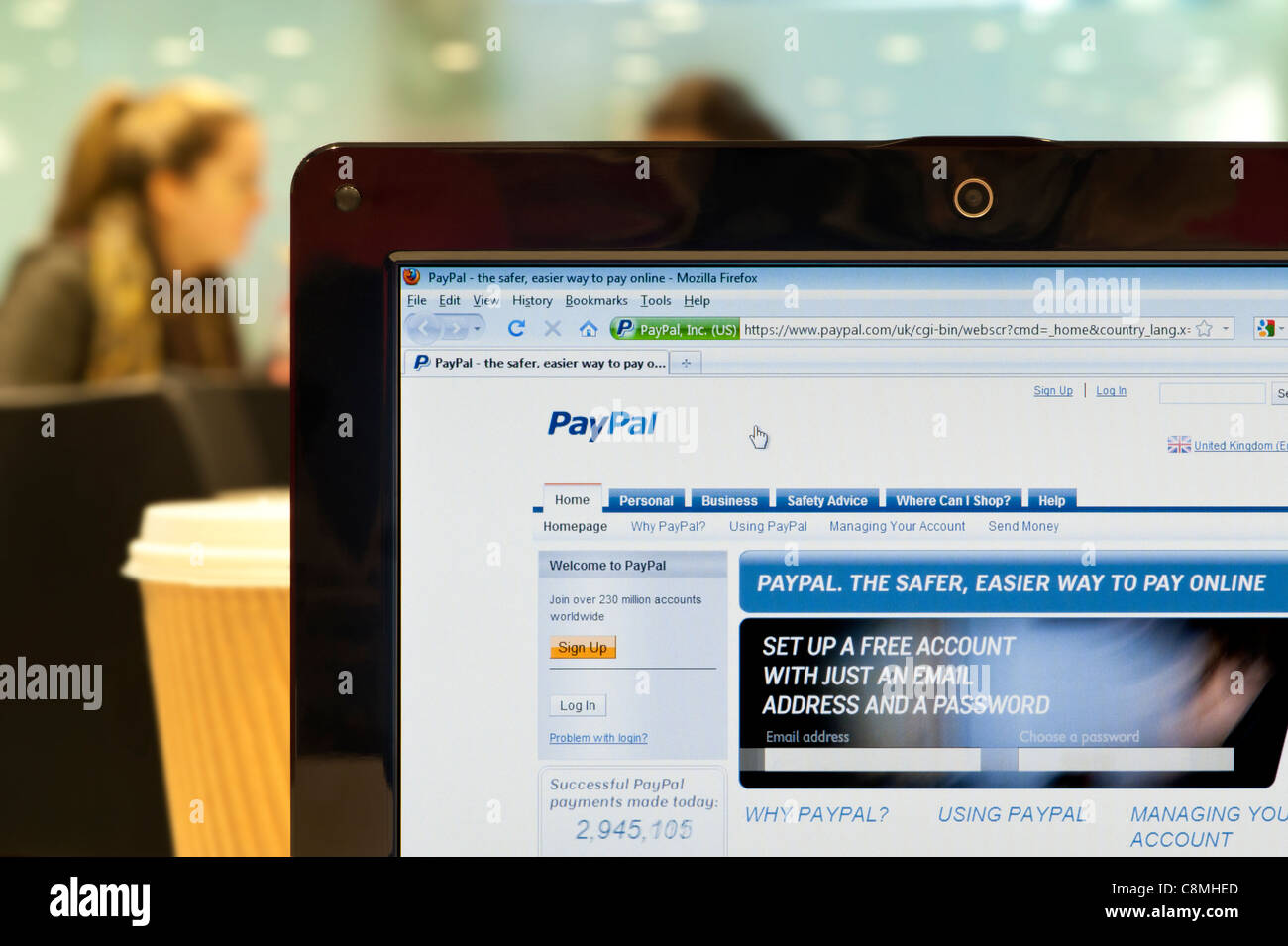 The PayPal website shot in a coffee shop environment (Editorial use only: print, TV, e-book and editorial website). Stock Photo