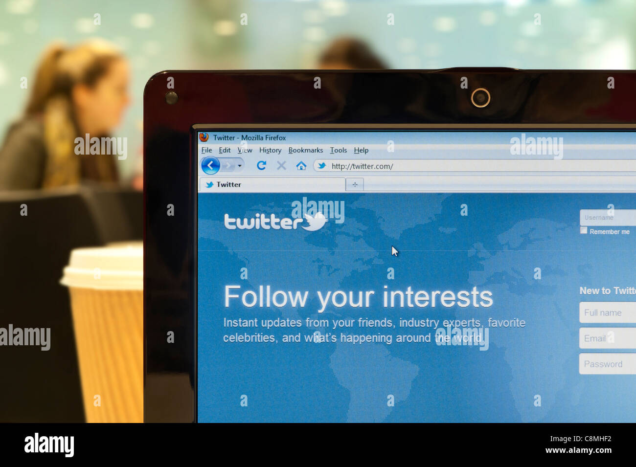 The Twitter website shot in a coffee shop environment (Editorial use only: print, TV, e-book and editorial website). Stock Photo