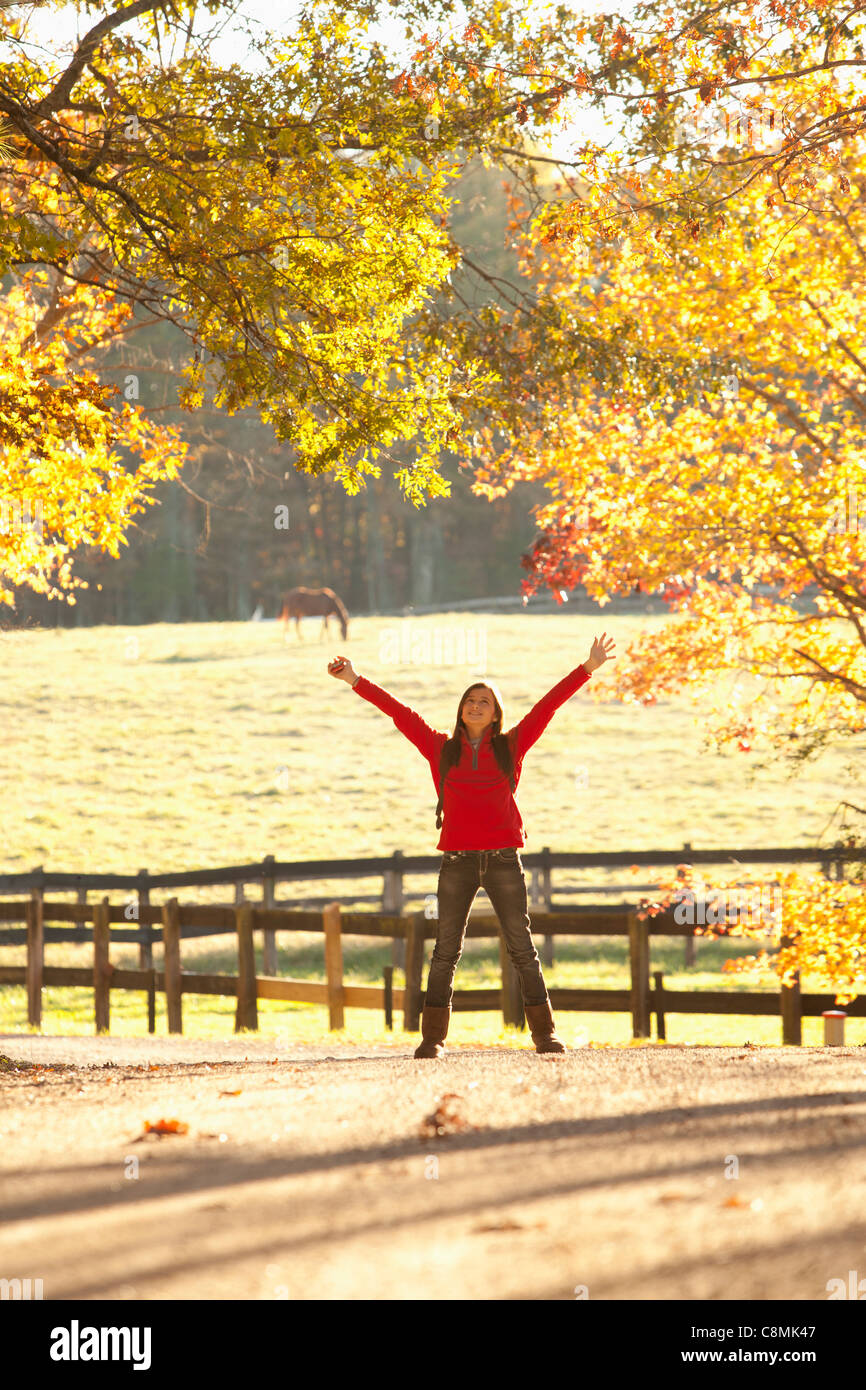 Caucasian girl standing with arms outstretched in countryside Stock Photo