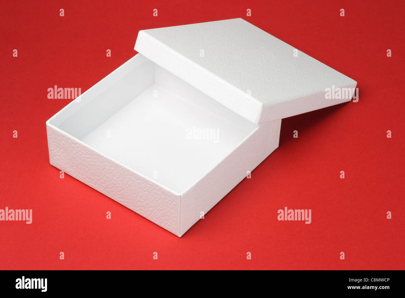 Open and empty white gift box on red background Stock Photo
