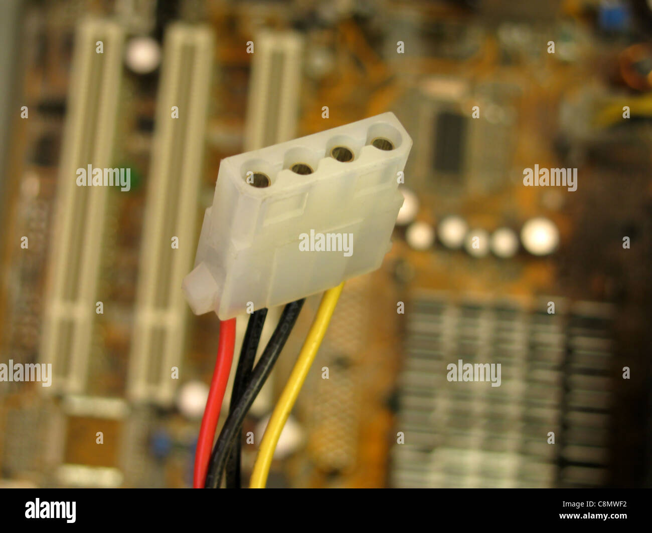 4-pin power cable over motherboard Stock Photo