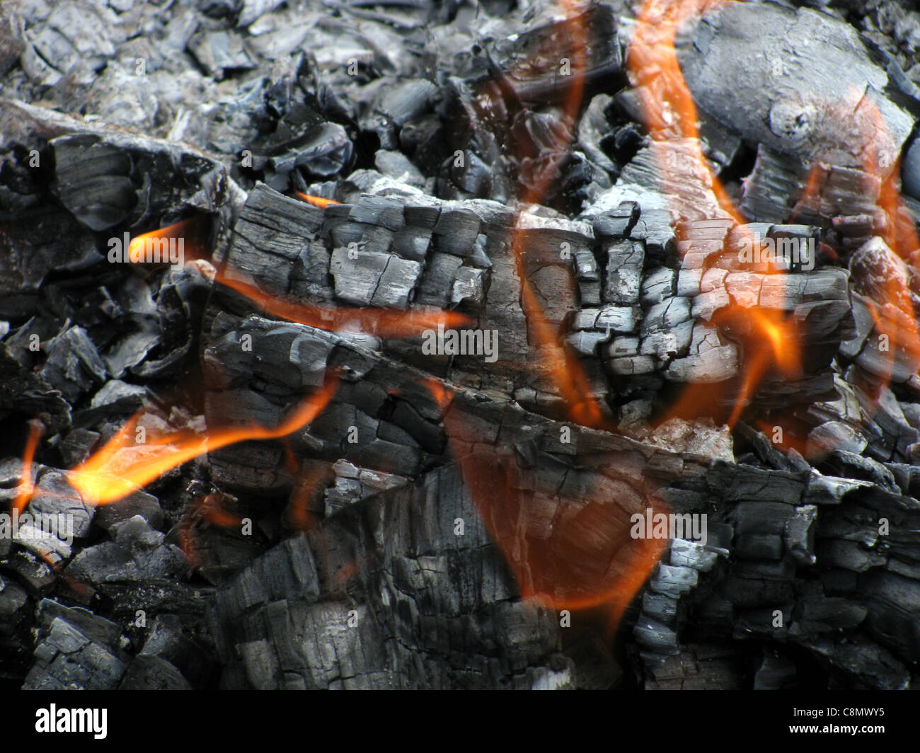 flame over ashes Stock Photo