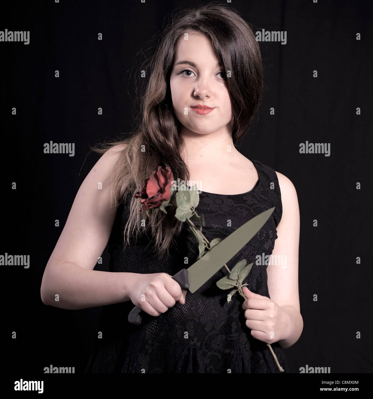 girl with red rose and a knife Stock Photo