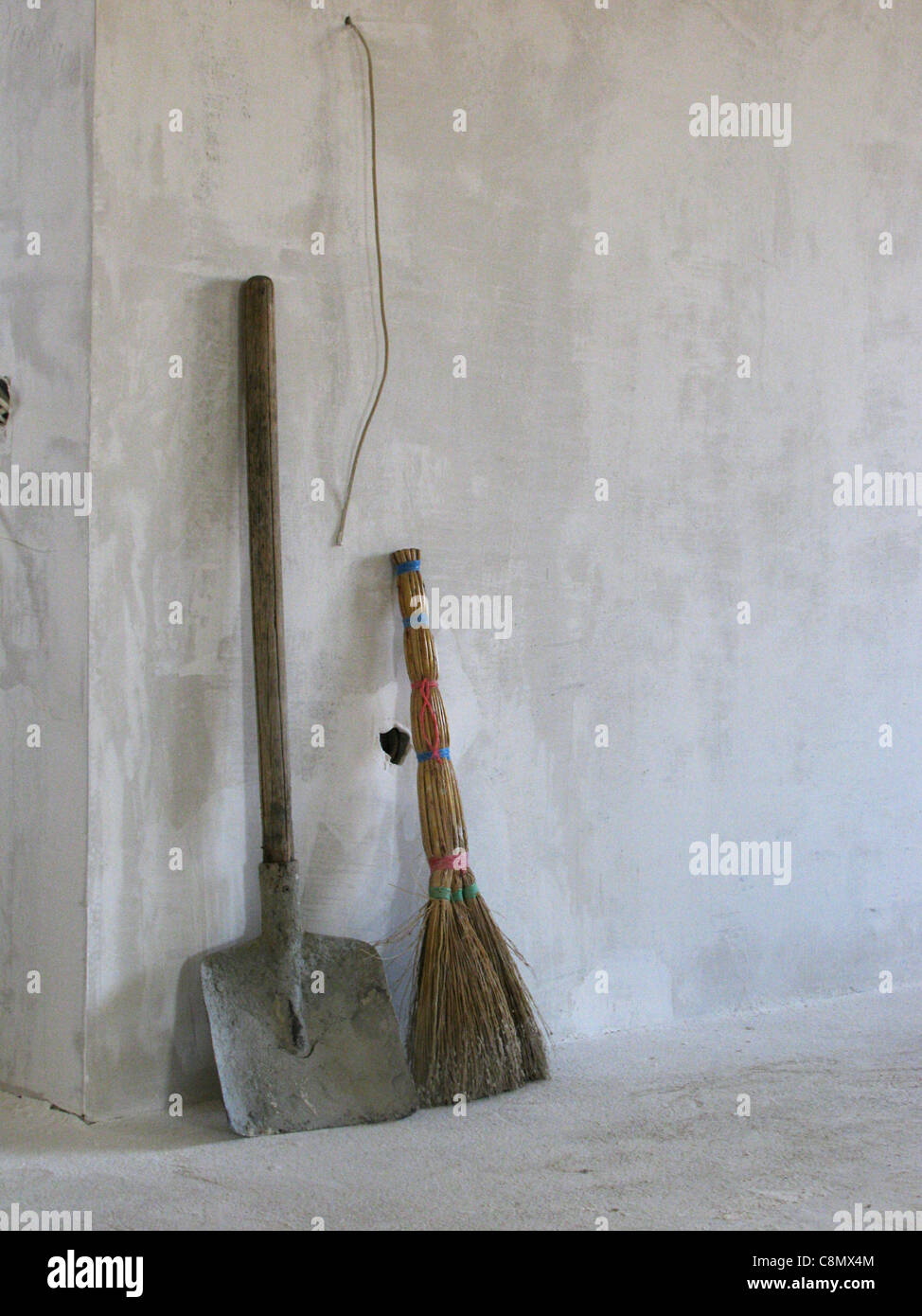 broom and shovel in a room being under construction Stock Photo