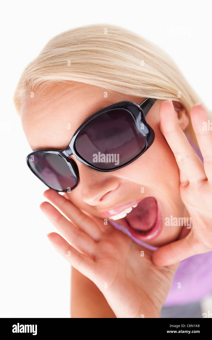 Blond lady with sunglasses in high spirits Stock Photo