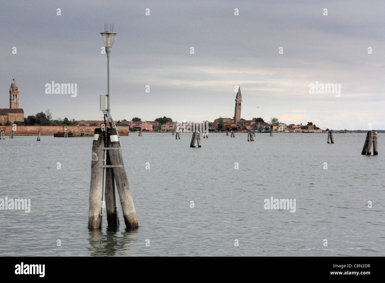Venetian Lagoon.  Background: Burano island with leaning church tower Campanile San Martino. Venice, Italy Stock Photo