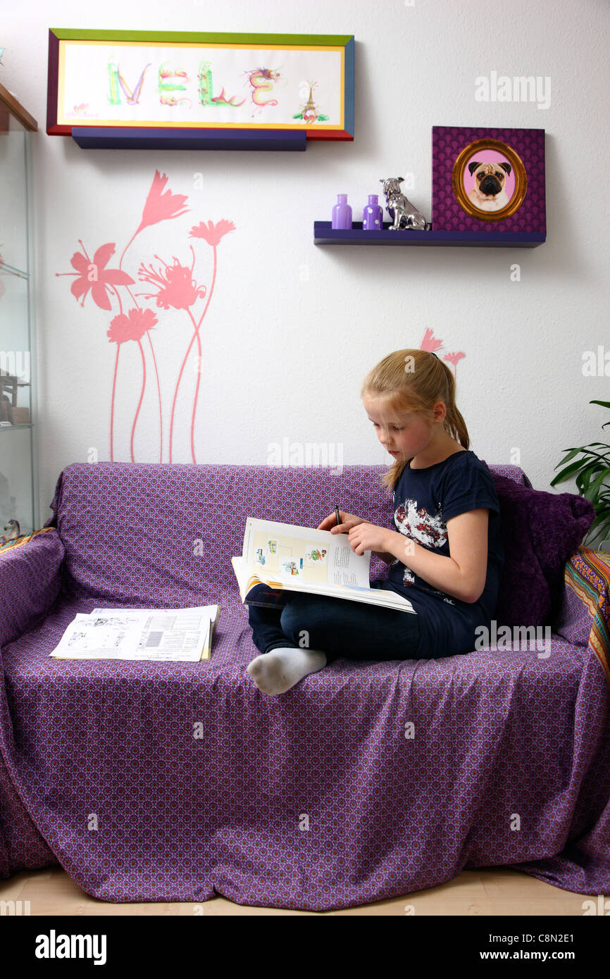 Girl, 10 years old, learning for school, at home in her room, doing homework. Stock Photo