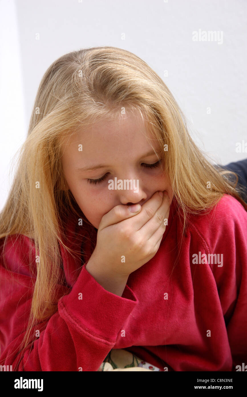 Young girl, 10 years old, sick in bed, having a flu. Stock Photo
