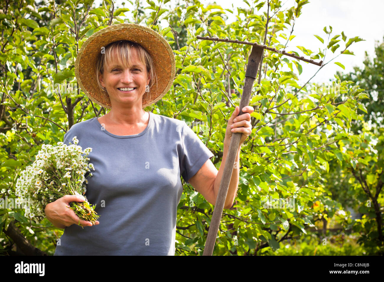 Portrait of happy mature woman in the garden Stock Photo - Alamy