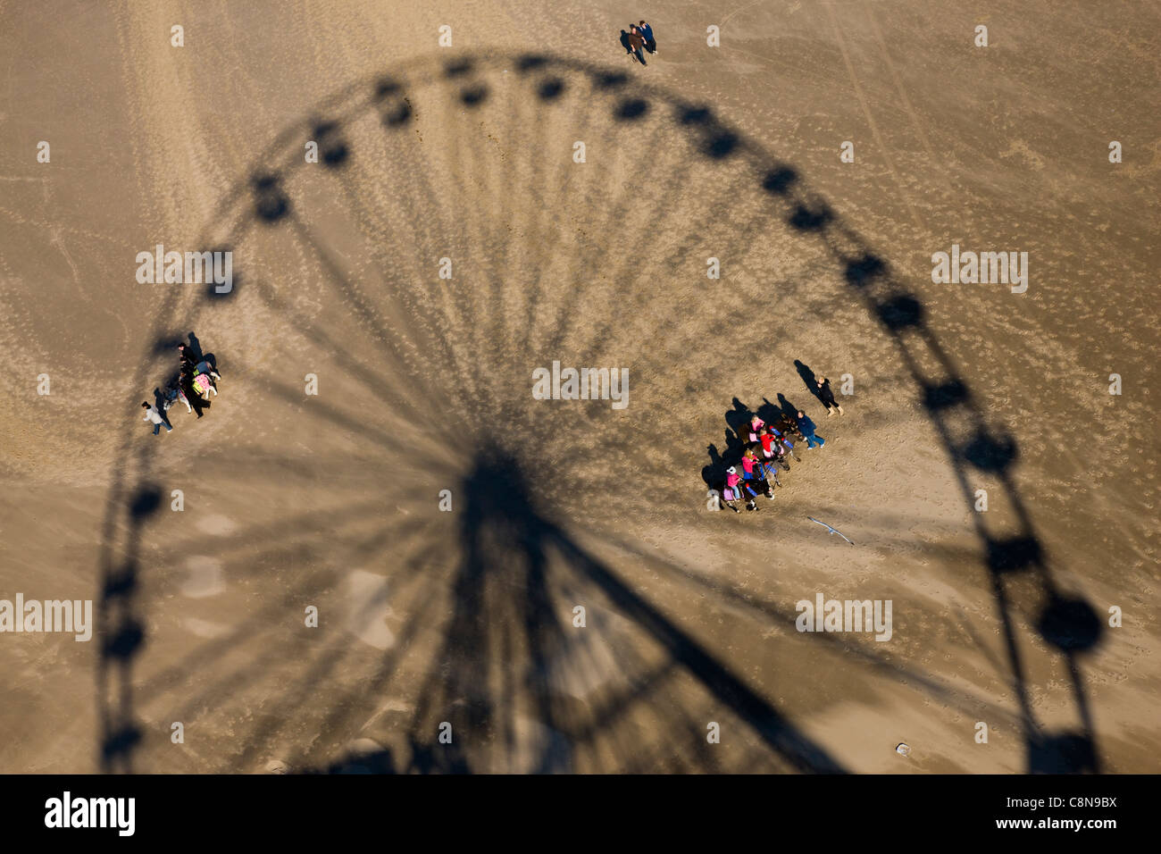 Shadow of the fairground ferris wheel on the beach in Blackpool, UK Stock Photo