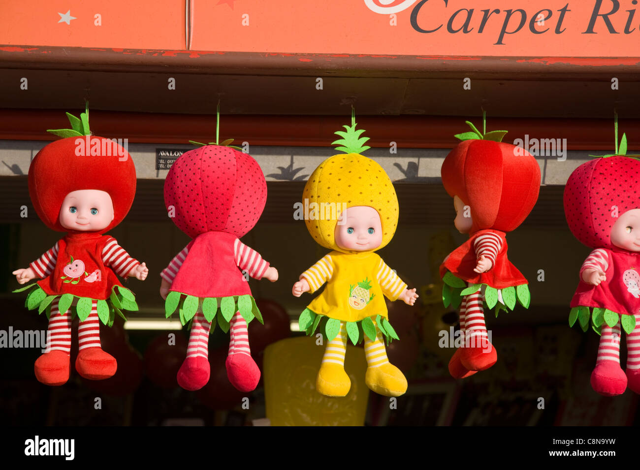 Fruit dolls, the next 'latest craze', according to the shopkeeper selling them from his stall in Blackpool, UK Stock Photo