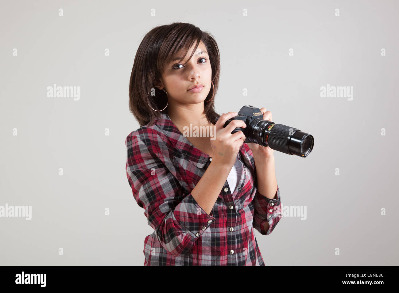 Mid school aged female student photographer. Stock Photo