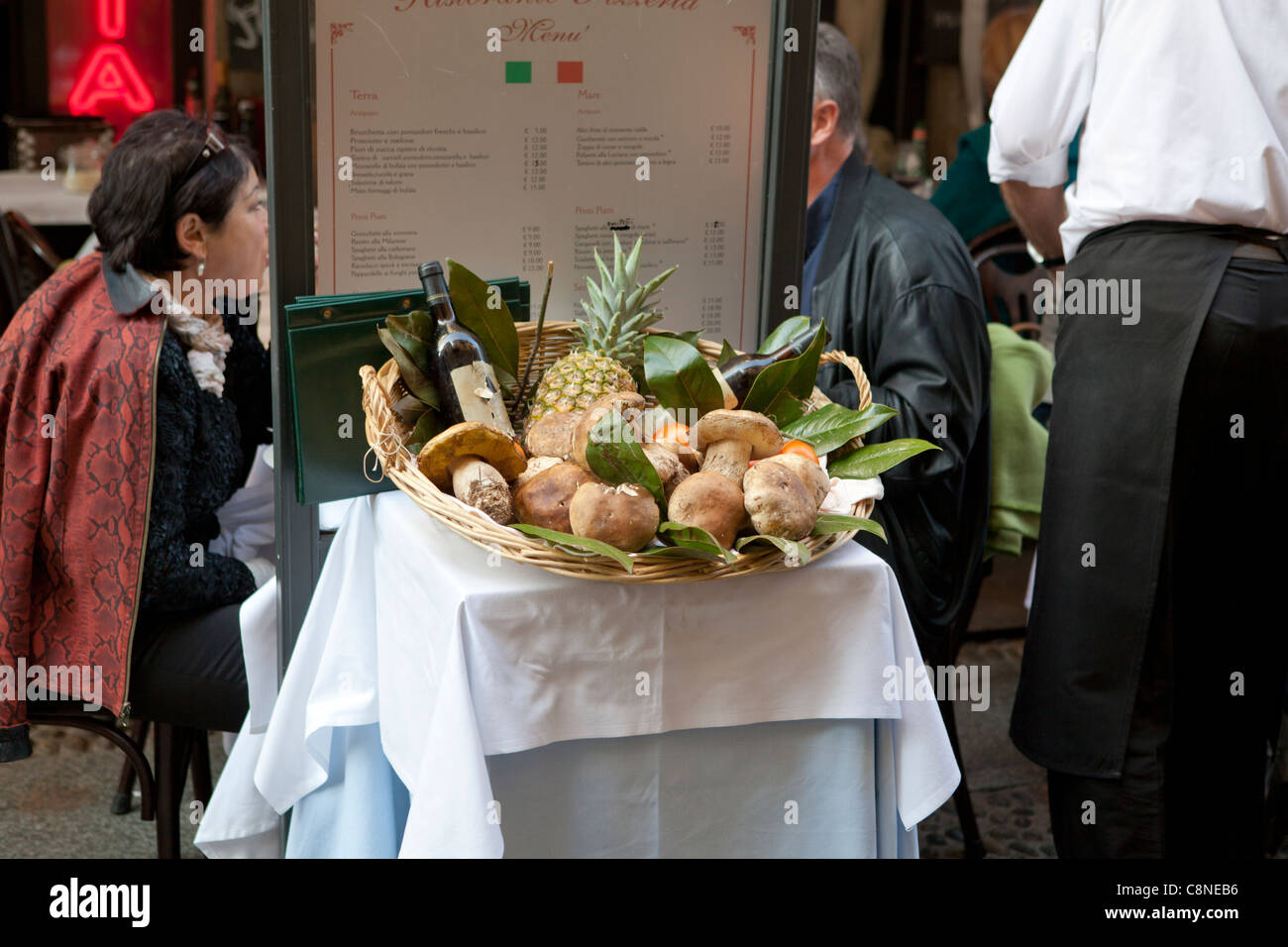 Brera district in Milan, Italy. Restaurant in the street exposing boletus fungi as main dish ingredients Stock Photo