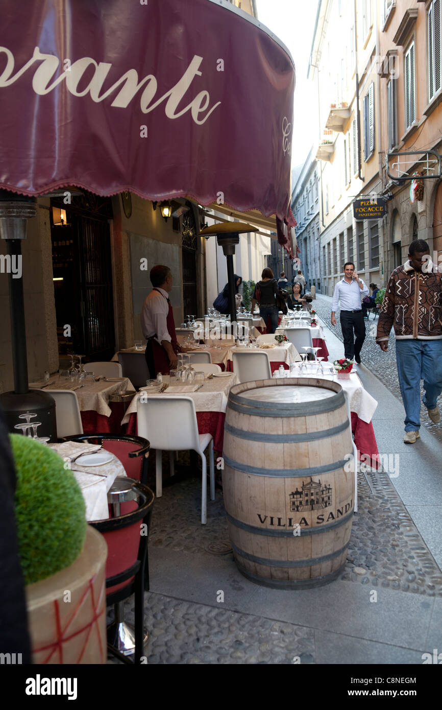 Fancy eating restaurant with street tables in the narrow streets of Brera district in the center of Milan, Lombardy, Italy Stock Photo